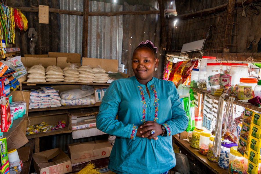 Pictured here is Kanini in front of her shop she opened in 2007 and where she sells household consumables and snacks.  